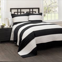 a black and white bed in a bedroom