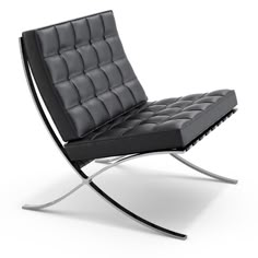 a black leather chair sitting on top of a metal frame