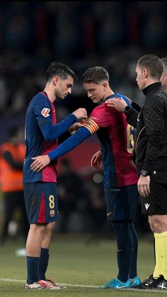 two soccer players are talking to each other