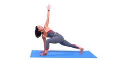 a woman is doing yoga on a blue mat with her arms up in the air