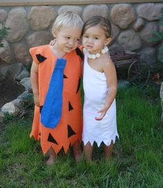 two children dressed up in costumes standing next to each other