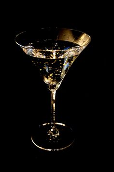 a glass filled with liquid sitting on top of a table