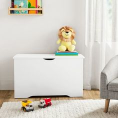 a toy lion sitting on top of a white dresser in a child's room