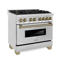 a white stove top oven with gold knobs