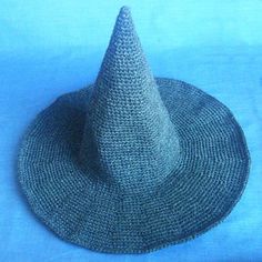 a knitted hat sitting on top of a blue cloth