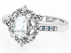 0.60ct Oval Aquamarine, 0.04ctw Round White Zircon With 0.05ctw Round Blue Diamond Accent Rhodium Over Sterling Silver Ring. Measures Approximately 0.52"L x 0.45"W. Not sizeable. Accent stones primarily zircon. White Diamond Cluster Ring With Accent Stones, White Oval Topaz Ring With Prong Setting, Oval White Topaz Ring With Diamond, White Oval Topaz Ring Fine Jewelry, White Topaz Ring With Diamond Accents, Fine Jewelry, White Oval Topaz Ring With Brilliant Cut, White Oval Topaz Ring With Center Stone, Aquamarine Blue, Blue Diamond