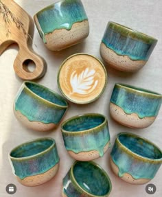 there are many cups and spoons that have been made to look like they're from pottery