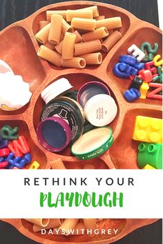 a wooden tray filled with lots of toys and words that read, rethik your playdouh