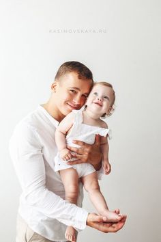 a man holding a baby in his arms