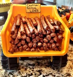 a yellow tray filled with hot dogs on top of a counter