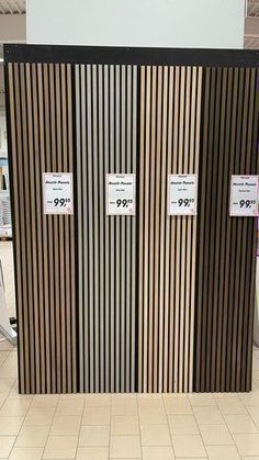 two doors with price tags on them in a store display area, one is black and the other is gold