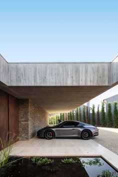 a car is parked in front of a house with a large window on the side