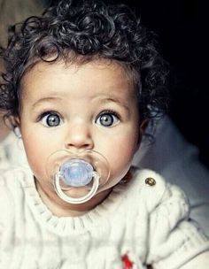 a baby with a pacifier in it's mouth