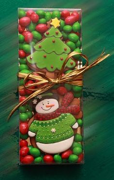 a christmas present wrapped in green and red wrapping paper with a snowman on it