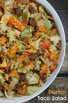 a white bowl filled with lots of food on top of a wooden table next to an instagram post