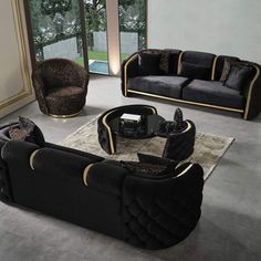 a living room filled with black couches and chairs on top of a carpeted floor