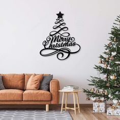 a living room with a christmas tree on the wall and merry christmas sign above it