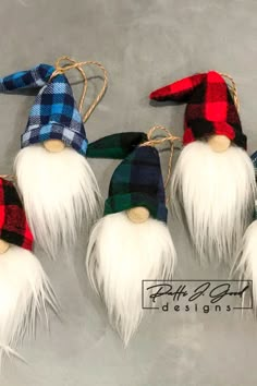 four gnomes with long white hair and red, green, blue and black flannel hats