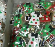 some decorated cookies in plastic wrappers on display