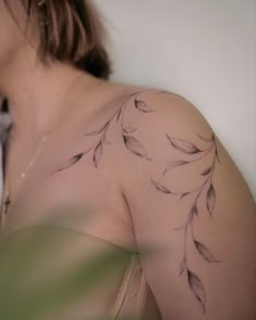 a woman with a tattoo on her shoulder