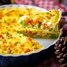 a close up of a casserole on a plate with a piece taken out