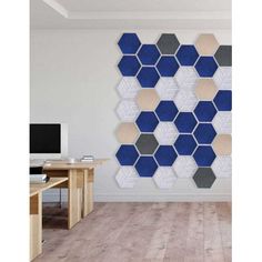 the wall is made up of hexagonal tiles in blue and grey colors, along with a computer desk