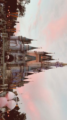 an image of a castle that is in the sky with pink and blue clouds behind it