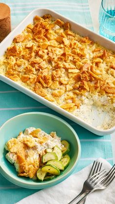 a casserole dish with cucumbers in it and a fork on the side