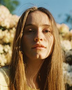 a woman with long hair looking at the camera