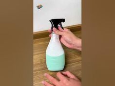 a person is using a spray bottle to clean the floor with a rag on it