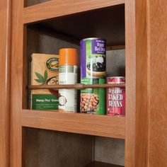 the shelves in this kitchen are filled with spices and canned food items, including cereals