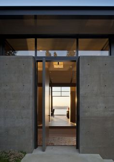 an entrance to a house with concrete walls