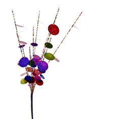 a vase filled with lots of different colored glass beads on top of a metal pole