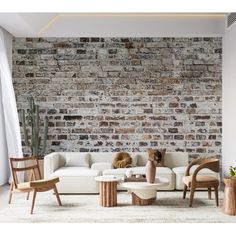 a living room filled with furniture and a brick wall