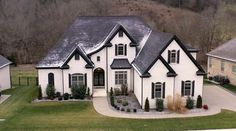 an aerial view of a white house with black trim