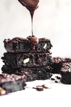 a stack of chocolate brownies sitting on top of each other