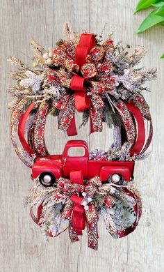 a red truck wreath hanging on the side of a wooden wall