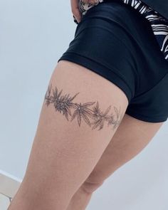 a woman with a tattoo on her thigh