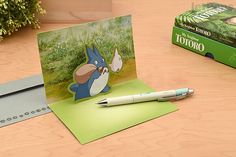 a card with an image of peter rabbit on it and a pen next to it