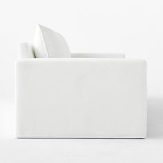 a white couch sitting on top of a white floor