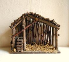 a nativity scene made out of sticks and logs