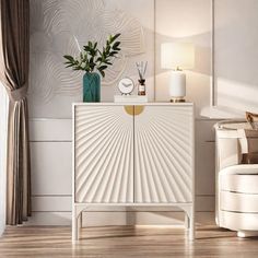 a white cabinet sitting in the middle of a living room next to a chair and lamp