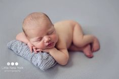 a baby sleeping on top of a blue blanket