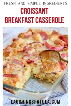 a glass casserole dish filled with croissant breakfast casserole and a serving spoon