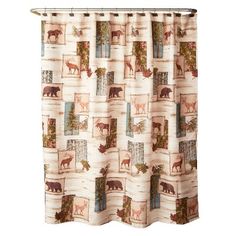 a shower curtain with animals and trees on it