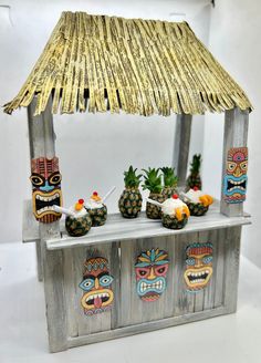 a tiki hut with pineapples, pineapples and pineapples