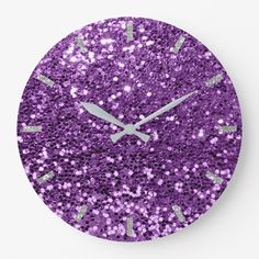 a purple clock with silver hands and numbers on the face that is covered in glitter