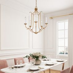 a dining room table with pink chairs and a chandelier