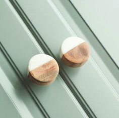 two wooden knobs on the side of a door