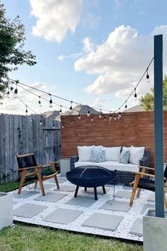 an outdoor patio with seating and string lights